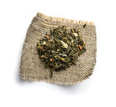 Green tea with aromatic additives. Top view on white background.