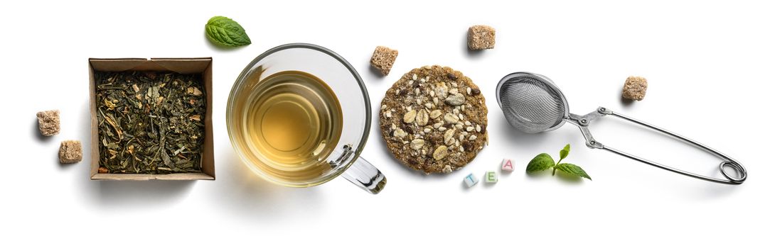 Green tea with natural aromatic additives and accessories. Top view on white background.