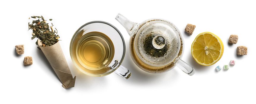 Green tea with natural aromatic additives and accessories. Top view on white background.