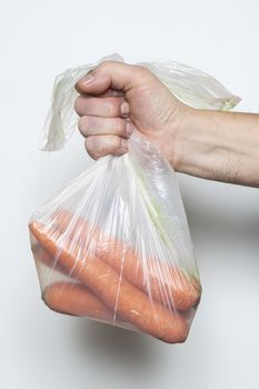 Some carrots in a plastic bag