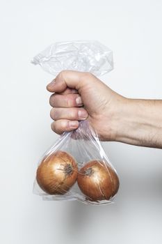 Some onions in a plastic bag