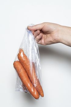 Some carrots in a plastic bag