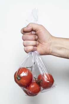 Some tomatoes in a plastic bag