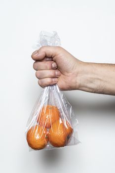 Some tangerines in a plastic bag