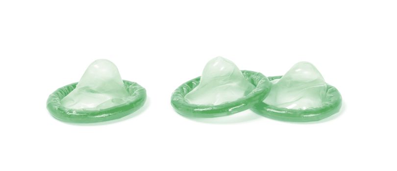 Green condom, isolated on a white background