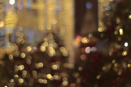 Colorful bokeh defocused Christmas garlands, Christmas fair. Festive abstract background.