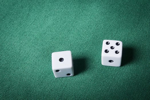 Dice on a table with green cloth