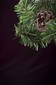 Close-up of artificial pine branch with pine cone