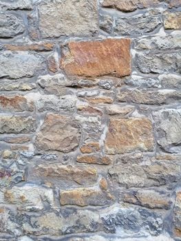 Old stone wall with moss and holes texture background.