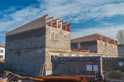 installation of wooden beams at house construction site. Building details with wood, timber and metal holders