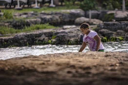 BAYAHIBE, DOMINICAN REPUBLIC 23 DECEMBER 2019: Poor Dominican children play in Bayahibe beach in total happiness and joy