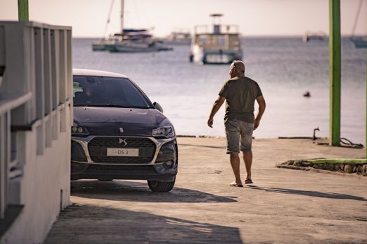 BAYAHIBE, DOMINICAN REPUBLIC 23 DECEMBER 2019: Man strolls on Bayahibe pier