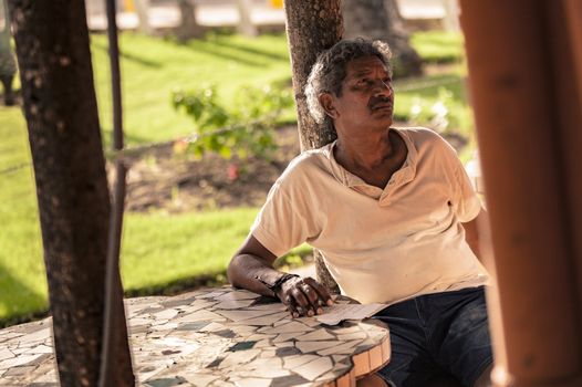 BAYAHIBE, DOMINICAN REPUBLIC 23 DECEMBER 2019: Dominican man sitted at bar