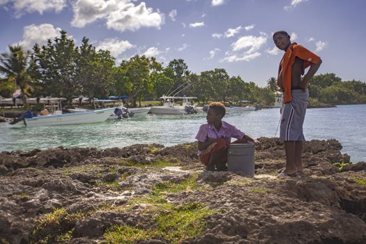 BAYAHIBE, DOMINICAN REPUBLIC 23 DECEMBER 2019: Poor Dominican children play in Bayahibe beach in total happiness and joy