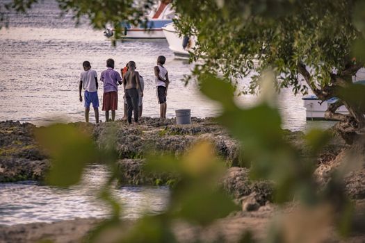 BAYAHIBE, DOMINICAN REPUBLIC 23 DECEMBER 2019: Poor Dominican children play in Bayahibe beach in total happiness and joy