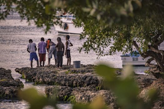 BAYAHIBE, DOMINICAN REPUBLIC 23 DECEMBER 2019: Poor Dominican children play in Bayahibe beach in total happiness and joy