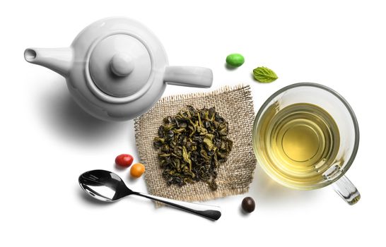 Green tea and accessories top view on white background.
