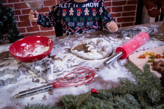 Dough and christmas cookie. Children making christmas cookies in the kitchen