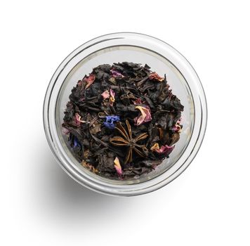 Black tea with natural aromatic additives. Top view on white background.