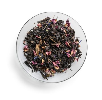 Black tea with natural aromatic additives. Top view on white background.