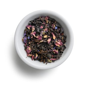 Black tea with natural aromatic additives. Top view on white background.