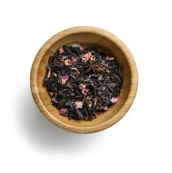 Black tea with natural aromatic additives. Top view on white background.