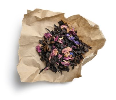Black tea with natural aromatic additives. Top view on white background.