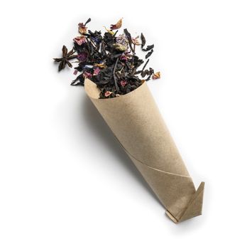 Black tea with natural aromatic additives. Top view on white background.