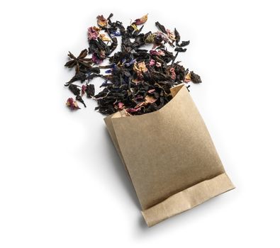 Black tea with natural aromatic additives. Top view on white background.