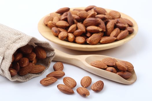 Close up of dry almonds nuts isolated over white background.