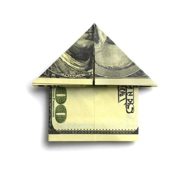100 us dollars in the shape of a house on a white background.