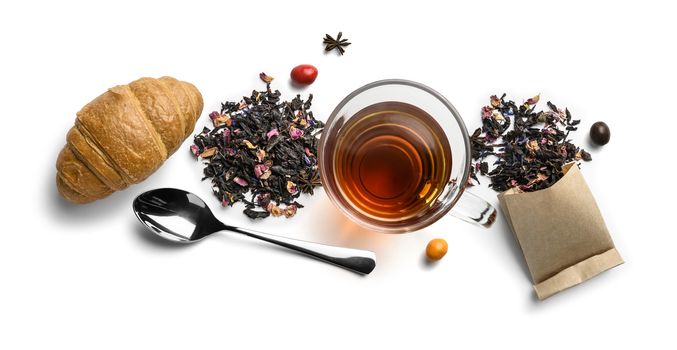 Black tea with natural aromatic additives and accessories. Top view on white background.