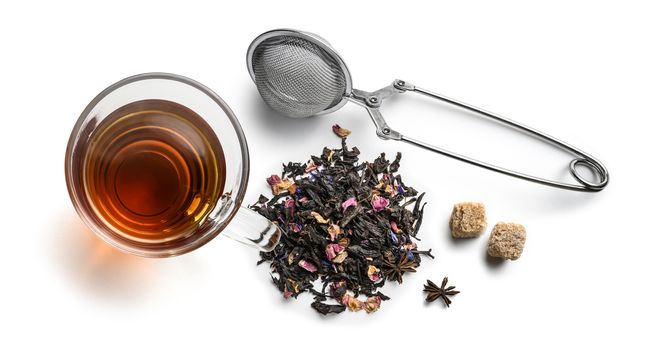 Black tea with natural aromatic additives and accessories. Top view on white background.