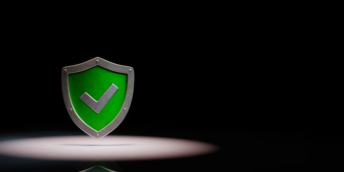 Green Metallic Shield Shape with Tick Symbol Spotlighted on Black Background with Copy Space 3D Illustration