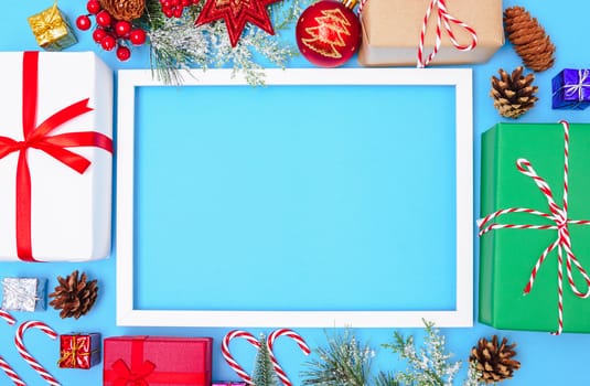 Happy New Year and Christmas day 2020, top view composition decoration photo frame on blue background with copy space for your text