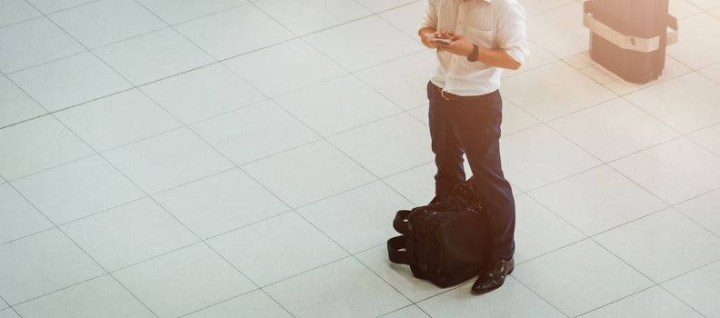 Man people traveling luggage bag he check in by smart phone in air port terminal building