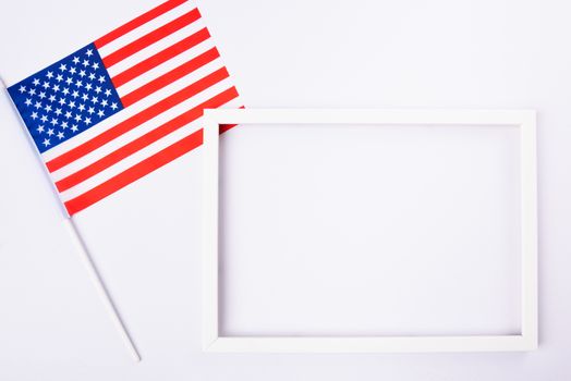 Martin luther king day, flat lay top view, American flag and photo frame on white background with copy space for your text