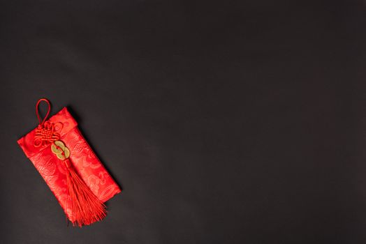 Chinese new year festival concept, flat lay top view, Happy Chinese new year with Red envelope (Character "FU" means fortune, blessing, wealth) on black background with copy space for your text