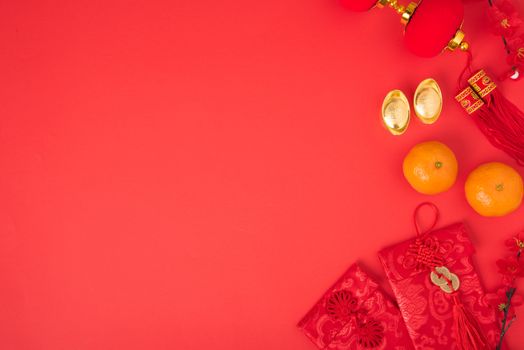 Chinese new year festival concept, flat lay top view, Happy Chinese new year with Red envelope and gold ingot (Character "FU" means fortune, blessing) on red background with copy space for text