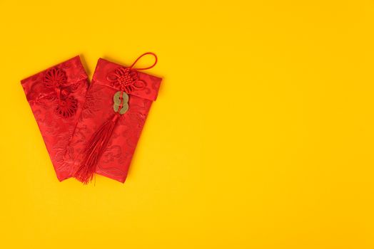 Chinese new year festival concept, flat lay top view, Happy Chinese new year with Red envelope (Character "FU" means fortune, blessing) on yellow background with copy space for text