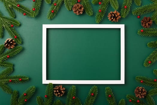 Happy new year, christmas day concept top view flat lay fir tree branches and decoration photo frame on Olive Green background with copy space for your text