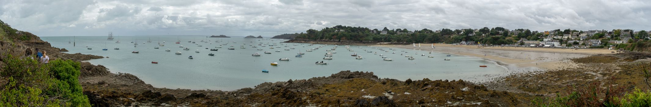 Sea and yachts during tide on sea shore of France in summer