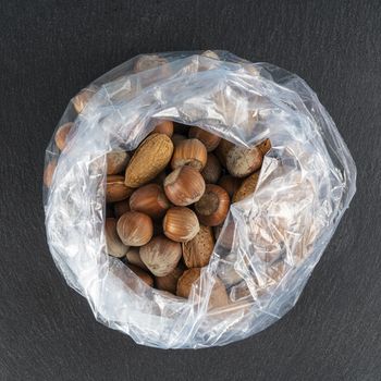 walnuts, peanuts and almonds on a plastic bag