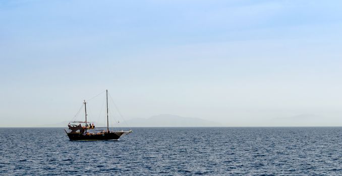 black yacht in the Red Sea on the background of the island in Sharm El Sheikh Egypt