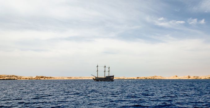 black yacht near the rocky shore of the Red Sea in Sharm El Sheikh Egypt