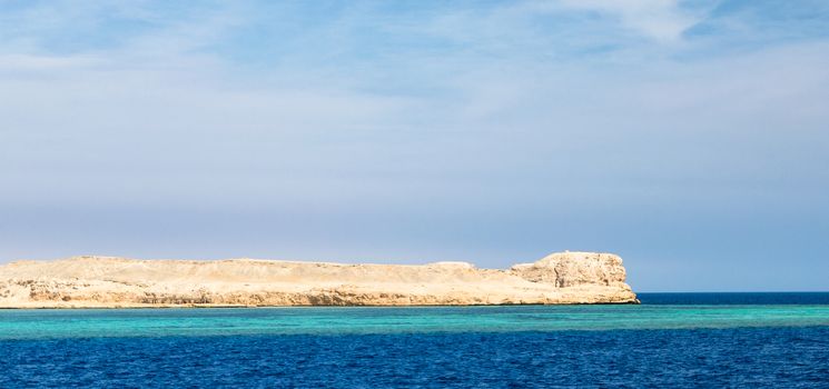 landscape rocky coast of the Red Sea and
blue sky with clouds in Sharm El Sheikh Egypt