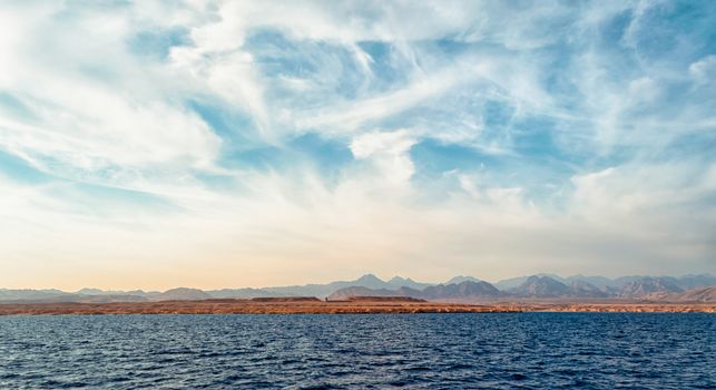landscape rocky coast of the Red Sea and
blue sky with clouds in Sharm El Sheikh Egypt