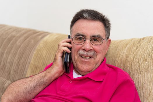 Portrait of a senior man happy talking on the phone