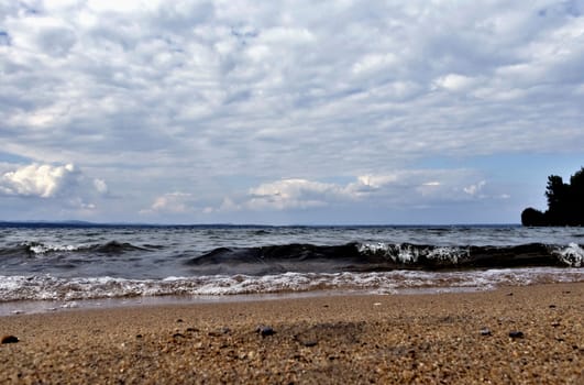 view of the lake with cumulonimbus clouds above it in windy weather, low point shooting