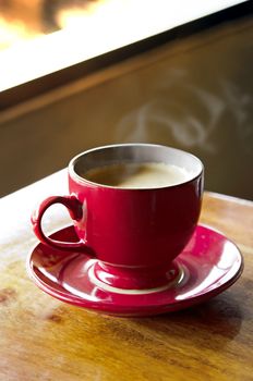 Cup of hot coffee latte on wood table in restaurant